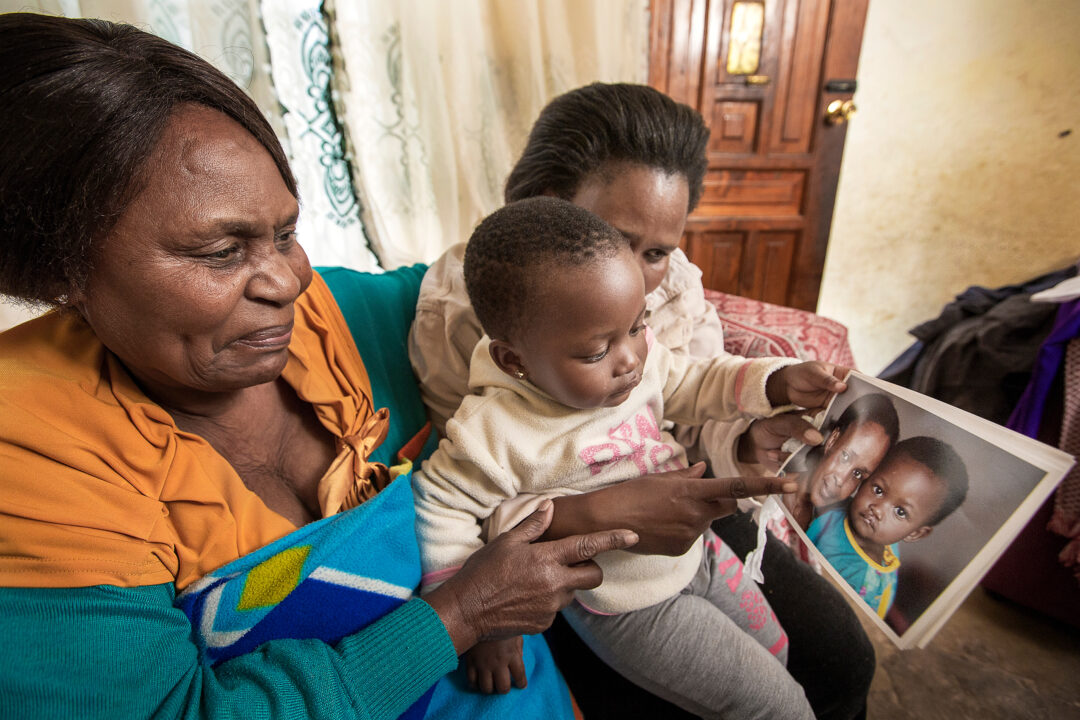 An emotional Lydia looks at photo of two-year-old Lungile before cleft surgery. Photo: Zute Lightfoot